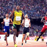 Jamaica\'s Usain Bolt exhibited his showmanship after his 200-meter triumph at the 2015 IAAF World Championships in Beijing. | MARK SHEARMAN
