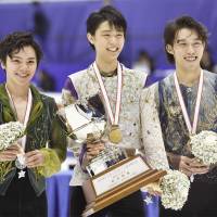 Champion Yuzuru Hanyu (center), runner-up Shoma Uno (left) and third-place finisher Takahito Mura receive their awards on Saturday after the men\'s free program at the All-Japan Championships in Sapporo. | KYODO