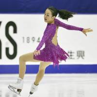 Mao Asada skates in the short program on Saturday in Sapporo. She sits in fifth place with 62.08 points. | KYODO