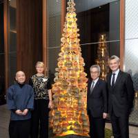 France-based paper installation artist Marianne Guely (second from left), who unites Japanese craft traditions in an original design with the Andaz Tokyo Christmas tree in the Andaz Salon, poses with, (from left), Takeshi Nishimura, Yuzen-engraving artisan, Shigeru Takeo, president of TAKEO Co. and Arnaud de Saint-Exupery, general manager of the Andaz Tokyo on Nov. 27. | YOSHIAKI MIURA