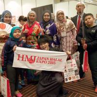Malaysian visitors pose at the expo, Nov. 26. | EDLEEN OTHMAN