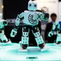 The Robitis OP2, a miniature robot developed by Robotis Co., dances during a demonstration at the International Robot Exhibition 2015 in Tokyo. The theme for this year\'s show, which ends Saturday, is \"making a future with robots.\" | BLOOMBERG