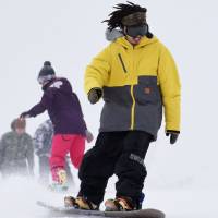 Snowboarders hit the slopes at Gokase Highland, Japan\'s southernmost ski resort, in Gokase, Miyazaki Prefecture, on the first day of the season on Friday. Workers had been busy topping up the slopes with artificial snow, according to staffers. | KYODO