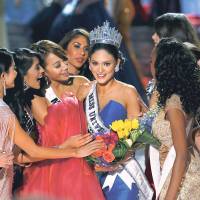 Miss Philippines, Pia Alonzo Wurtzbach (center), is surrounded by other contestants after winning the 2015 Miss Universe Pageant in Las Vegas on Sunday. Miss Colombia was left open-mouthed after the announcer named her by mistake. | REUTERS