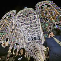 The Kobe Luminarie is lit up in a test run on Tuesday evening. The annual illuminations were inaugurated in December 1995, 11 months after the Great Hanshin Earthquake struck the city. They can be seen from Friday until Dec. 13. | KYODO