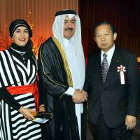 Qatar Ambassador Yousef Mohamed Bilal (center) and his wife Jamila Al Suwaidi welcome Chairman of the Liberal Democratic Party General Council and Chairman of the Japan-Qatar Parliamentary Friendship League Toshihiro Nikai during a reception celebrating the country\'s National Day at the Imperial Hotel, Tokyo on Dec. 18. | YOSHIAKI MIURA