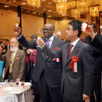 Kenyan Ambassador Solomon Karanja Maina (third from right) joins in a toast with Special Advisor to the Prime Minister of Japan Katsuyuki Kawai (second from right) and Ambassador Norio Maruyama (right), director general for the Africa Affairs department, Ministry of Foreign Affairs, at the Marriott, Tokyo on Dec. 14. | KENYA EMBASSY
