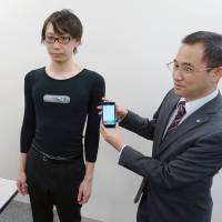 A man models an electrically conductive garment that transmits data to a user\'s cellphone. It was developed by underwear-maker Gunze Ltd. and electronics giant NEC Corp. | KYODO