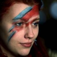 A fan of David Bowie joins other revellers in London to celebrate the life of the musician after the announcement of his death on Jan. 11. | REUTERS