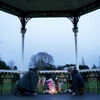 Fans leave flowers at a bandstand named after David Bowie where he once performed in Beckenham, South London, Jan. 11. | REUTERS