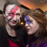 Bowie fans pose as they wait to hear collaborators Tony Visconti and Mick Woodmansey perform Bowie\'s 1970 album “The Man Who Sold The World” at Toronto\'s Opera House concert venue, Jan. 12. | NATHAN DENETTE/ THE CANADIAN PRESS VIA AP