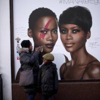 An ad for the cosmetic range of David Bowie’s wife Iman has also been embellished a la Ziggy Stardust in Brixton, south London. | AP