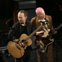Summer guests: A picture from a Paris gig shows Radiohead singer Thom Yorke (left) performing with  Red Hot Chili Peppers bassist Flea (right) last month. Yorke is set to visit Japan with Radiohead this summer. | AFP-JIJI