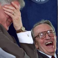 U.S. President Bill Clinton (left) laughs during a ceremony to dedicate a vaccine research center to former Sen. Dale Bumpers (right) and his wife, Betty, at the National Institute of Health in Bethesda, Maryland, on June 9, 1999. | REUTERS