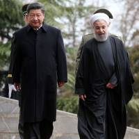 Iranian President Hassan Rouhani welcomes Chinese President Xi Jinping at the Saadabad Palace in Tehran on Saturday. As it seeks closer ties with China, Khamenei says that Iran never trusted the West