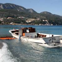 This vessel was used by migrants, many of whom drowned, in a crossing from Turkey to Greece. It is now half-submerged and docked at the village of Kokkari on the eastern Greek island of Samos on Thursday. | AP