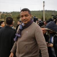 U.N. humanitarian coordinator for Syria Yacoub El Hillo looks on after talking to journalists as a convoy of aid from the Syrian Arab Red Crescent waits on the outskirts of besieged rebel-held Syrian town of Madaya, on Thursday. | AFP-JIJI