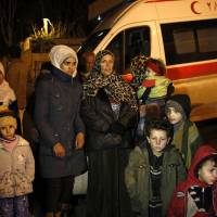People wait to leave the besieged town of Madaya, northwest of Damascus, Monday. | AP