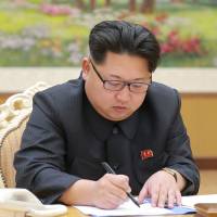 This picture taken on Sunday in Pyongyang and released on Thursday shows North Korean leader Kim Jong Un signing a document for a hydrogen bomb test. | KCNA via KNS / AFP-JIJI