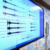 Japan Meteorological Agency officer Yohei Hasegawa displays a chart showing seismic activity from North Korea\'s latest nuclear test (top left, recorded in China) and earlier tests, plus an earthquake at bottom, in Tokyo on Wednesday. | AFP-JIJI