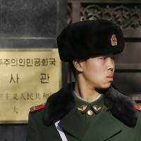 A soldier stands guard at the main gate of the North Korean Embassy in Beijing on Wednesday. | REUTERS