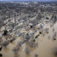 Houses are surrounded by floodwater Dec. 31 in Arnold, Missouri. Federal weather officials said December\'s wild El Nino pushed 2015 in the U.S. to near-record levels for heat, moisture and downright extreme conditions. | AP