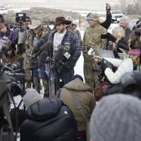 Ammon Bundy, one of the sons of Nevada rancher Cliven Bundy, speaks with reporters during a news conference at Malheur National Wildlife Refuge headquarters Monday near Burns, Oregon. Bundy, who was involved in a 2014 standoff with the government over grazing rights, told reporters on Monday that two local ranchers who face long prison sentences for setting fire to land have been treated unfairly. | AP