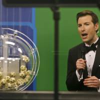 Host Sam Arlen speaks as the winning Powerball numbers are about to be drawn at the Florida Lottery studio in Tallahassee, Florida, Saturday. The winning numbers are 32-16-19-57-34 and the Powerball number is 13. The Powerball jackpot is a record-setting $949.8 million. Powerball jackpot at world record $1.3 billion and growing