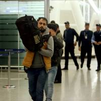 Iraqi refugees returning from Germany arrive at Irbil airport in Iraq Wednesday. | REUTERS