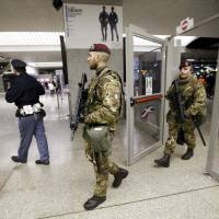 Armed officers patrol Termini Station, in Rome, Monday. Earlier Monday Italian authorities arrested a Moroccan citizen living in southern Italy suspected of seeking to become a foreign fighter for Islamic State. Italy\'s interior minister, Angelino Alfano, said that the arrest demonstrated the efficiency of new anti-terrorism measures adopted last spring. | AP