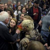 U.S. Democratic presidential candidate Bernie Sanders greets supporters at a town hall at Upper Iowa University in Fayette, Iowa, Sunday. | REUTERS