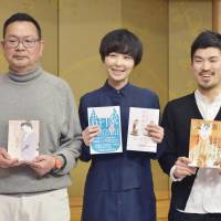 Bumpei Aoyama (left), who won the Naoki Prize, poses with Yukiko Motoya (center) and Yusho Takiguchi, co-winners of the Akutagawa Prize, at a Tokyo hotel on Tuesday. | KYODO