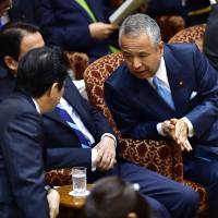 Akira Amari, state minister for economic revitalization (right), chats with Prime Minister Shinzo Abe before an Upper House Audit Committee session on Thursday. | AFP-JIJI