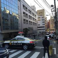A photo provided by a bystander shows police sealing off a street outside The British School in Tokyo in Shibuya Ward on Thursday. | KYODO