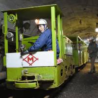A tram runs through a tunnel in the now-closed Ikeshima coal mine on Dec. 18 in Nagasaki. | KYODO