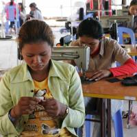 Women make various products with sewing machines at the Community Factory in Sout Nikom in northwestern Cambodia in this undated photo. | COURTESY OF KAMONOHASHI PROJECT