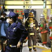 Police and firefighters respond to smoke coming from a ceiling duct in Tokyo\'s Ginza Station on Tuesday morning. | KYODO