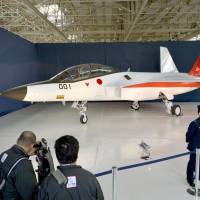 A prototype of the first Japan-made stealth fighter is shown to the media Thursday at a Mitsubishi Heavy Industries Ltd. factory in Aichi Prefecture. | KYODO