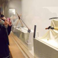 A woman takes a picture of the legendary sword Heshikiri Hasebe diplayed at Fukuoka City Museum on Jan. 11. | KYODO