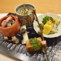 Bricolage of flavor: A selection of salads accompanied by a sprig of cherry blossom — a hint of the warm weather to come. Rikyu: Playing games with traditional 'kaiseki' cuisine