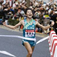 Aoyama Gakuin anchor Toshinori Watanabe crosses the finish line as his school becomes the first in 39 years to complete a wire-to-wire victory in the Hakone Ekiden on Sunday. Aoyama Gakuin won the title for the second consecutive year. | KYODO