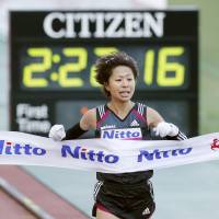 Kayoko Fukushi crosses the line to win the Osaka Marathon on Sunday. | KYODO