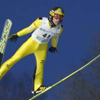 Noriaki Kasai soars through the air during a World Cup ski jump event on Saturday in Sapporo. Kasai earned a fourth-place finish. | KYODO