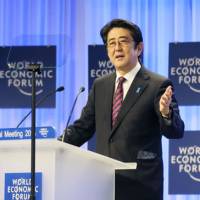 Prime Minister Shinzo Abe makes a speech on Jan. 22, 2014, at the opening plenary session of the WEF 2014 annual meeting in Davos. | CABINET PUBLIC RELATIONS OFFICE