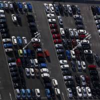 Vehicles sit parked in Yokohama on Feb. 9. Despite more than three years of Abenomics, the era of easy gains in Japan\'s stock market is over, a Japanese hedge fund has warned. | BLOOMBERG