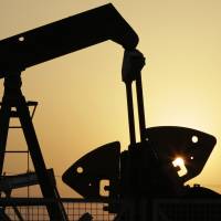 Oil pumps work in the desert oil fields of Sakhir, Bahrain, last September. Russia\'s energy minister said Tuesday that it has agreed with Saudi Arabia, Qatar and Venezuela to freeze oil production at January 2016 levels if other producers do the same following a closed-door meeting in the Doha. | AP