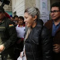 Gabriela Zapata is escorted out of a police station to the prosecutors’ office in La Paz on Saturday. Bolivian leader's former lover is arrested for alleged influence-peddling