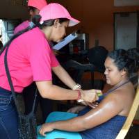 A health worker sprays mosquito repellent on a pregnant woman\'s arm during a campaign to fight the spread of Zika virus in the municipality of Soledad near Barranquilla, Colombia, on Feb. 1. | REUTERS