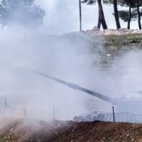 Turkish tanks fire from their army position near the Oncupinar crossing gate close to the town of Kilis, south central Turkey, toward the Syria border, on Feb. 17. Alarmed by the advances of Syrian Kurdish forces in Aleppo province near the border, Ankara has in recent days bombed their positions, defying international calls for a halt to the strikes. | AFP-JIJI