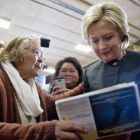 Democratic presidential hopeful Hillary Clinton signs an autograph for a supporter during a campaign event on Jan. 25 at the Knoxville School District Administration Office in Knoxville, Iowa. | AP